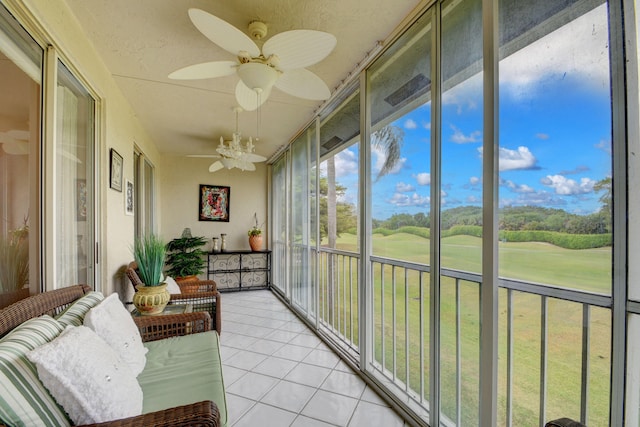 sunroom featuring ceiling fan