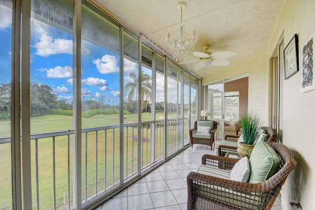 sunroom / solarium with a notable chandelier