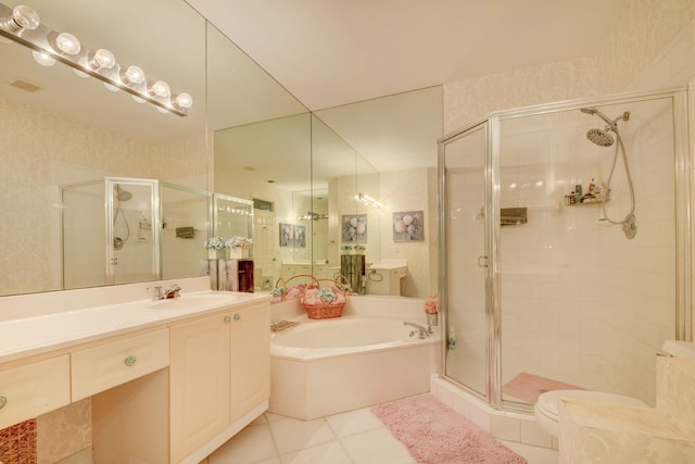 bathroom featuring tile patterned flooring, vanity, and separate shower and tub