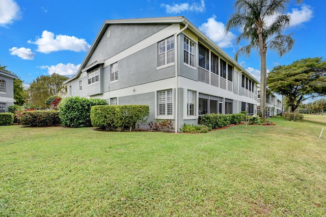 view of property exterior with a yard