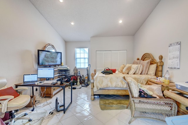 tiled bedroom featuring a textured ceiling and vaulted ceiling