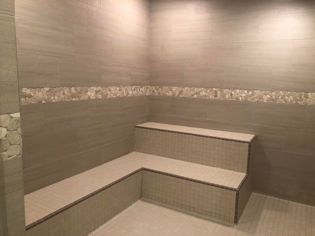 bathroom featuring tile patterned flooring and tile walls