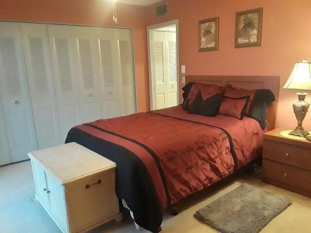 bedroom featuring light colored carpet and a closet