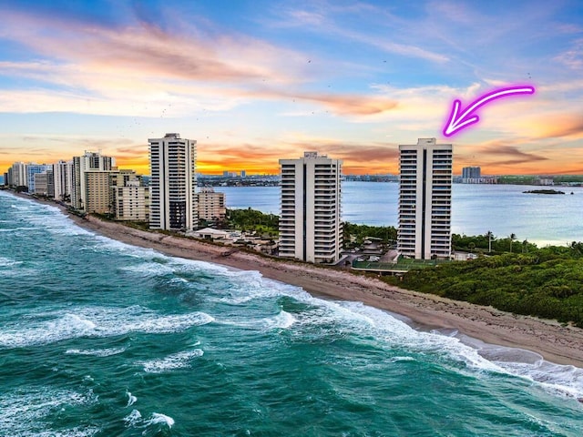 exterior space with a water view and a view of the beach