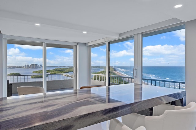 unfurnished sunroom featuring a healthy amount of sunlight and a water view