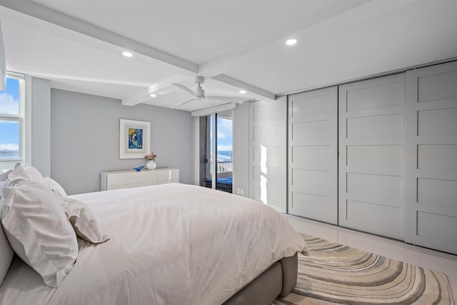 bedroom featuring ceiling fan, beam ceiling, and access to outside