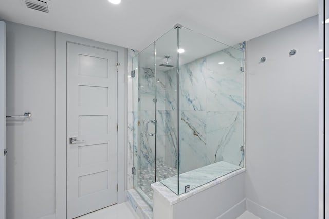 bathroom with a shower with shower door