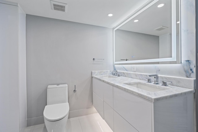 bathroom featuring tile patterned floors, vanity, and toilet