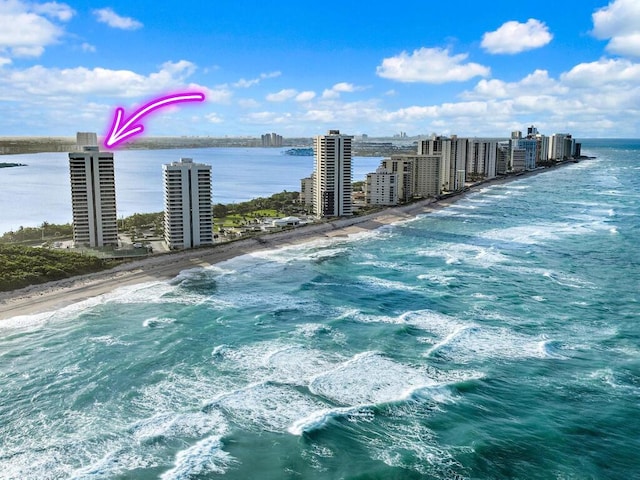 birds eye view of property with a water view and a view of the beach