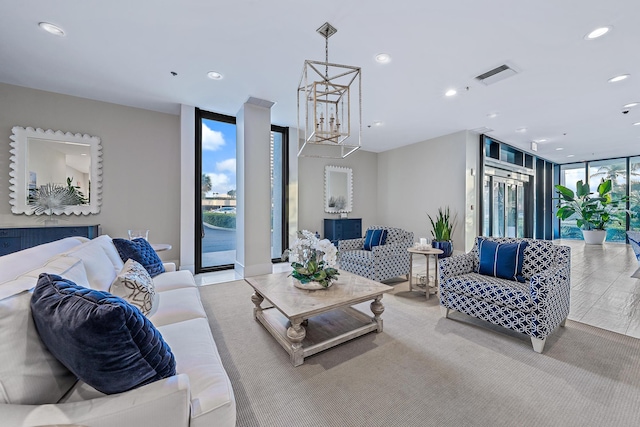 living room with light wood-type flooring and floor to ceiling windows