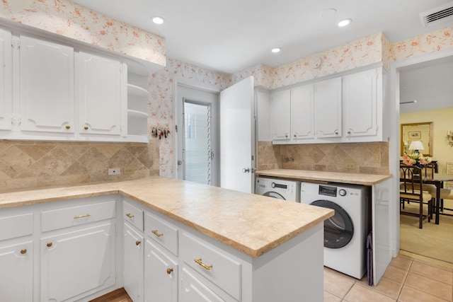 kitchen with white cabinets, decorative backsplash, kitchen peninsula, and light tile patterned floors