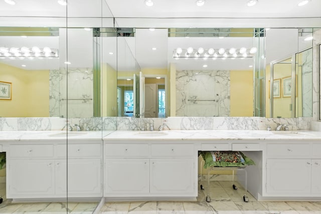 bathroom with vanity and a shower with shower door