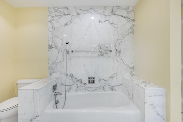 bathroom featuring toilet and a bath