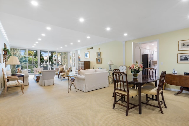 carpeted dining area featuring floor to ceiling windows and ornamental molding