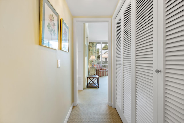 hallway featuring light carpet