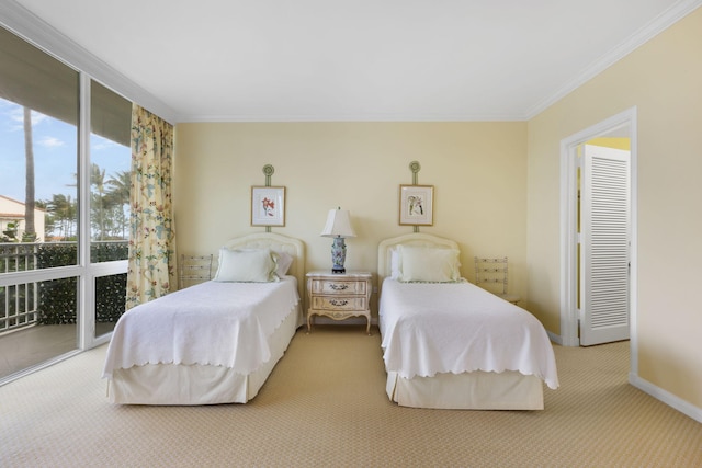 carpeted bedroom featuring access to exterior and crown molding