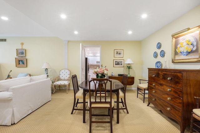 dining room featuring light carpet and ornamental molding