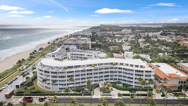 drone / aerial view with a water view and a beach view