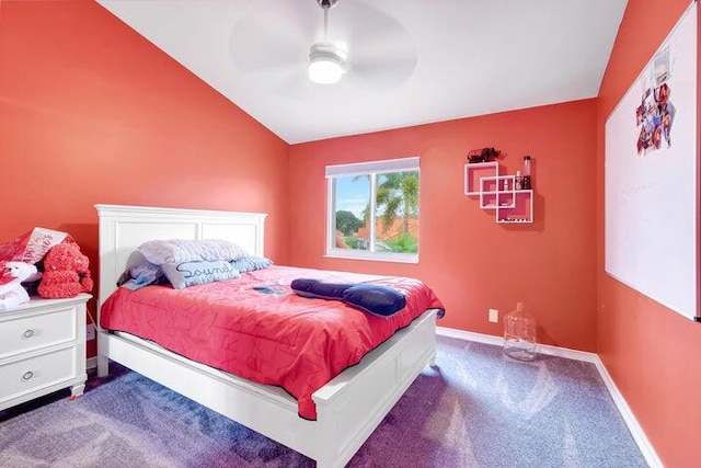 carpeted bedroom featuring ceiling fan and vaulted ceiling