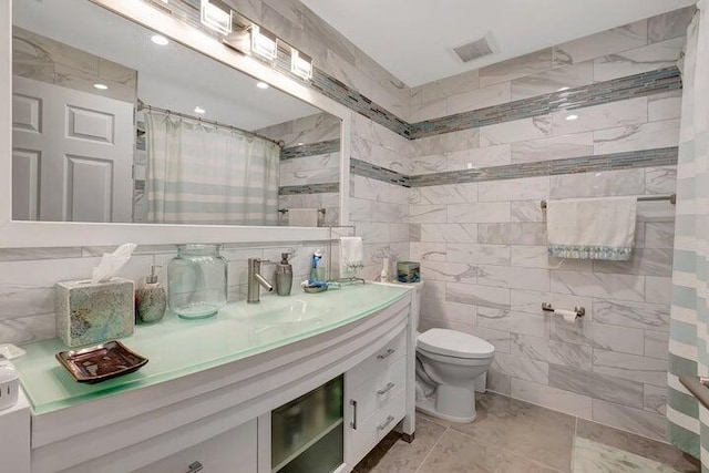 bathroom featuring a shower with shower curtain, vanity, toilet, and tile walls