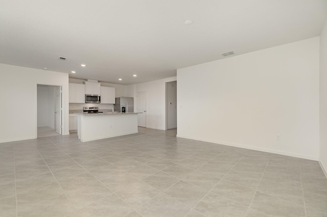 unfurnished living room with light tile patterned floors