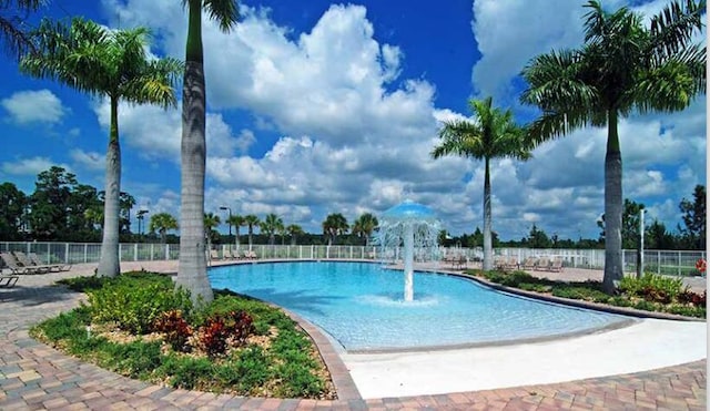 view of swimming pool with pool water feature