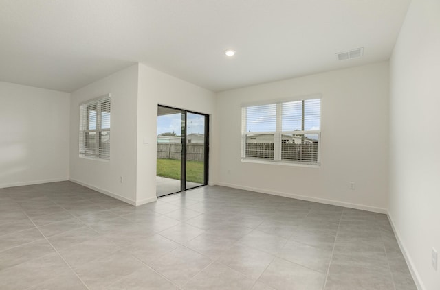 spare room featuring light tile patterned floors