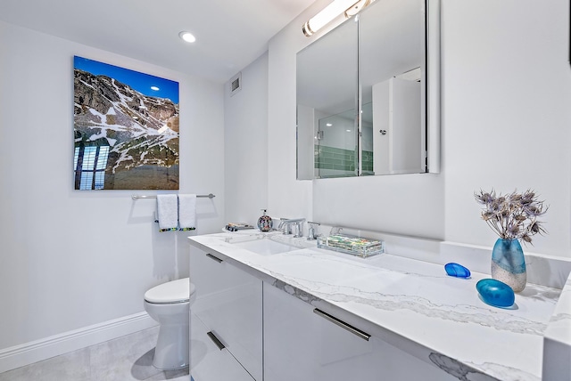 bathroom with vanity, toilet, and walk in shower