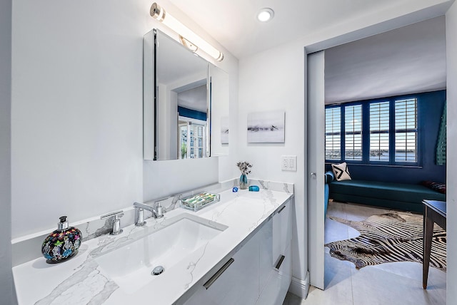 bathroom with tile patterned flooring, vanity, and plenty of natural light