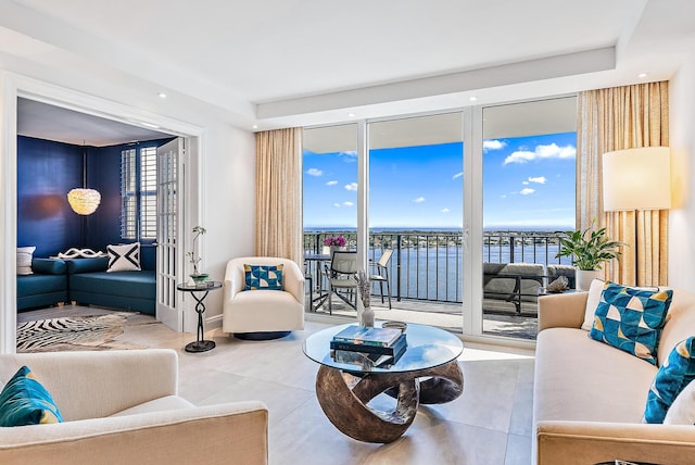 living room featuring a water view and tile patterned floors