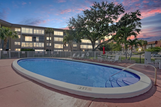 view of pool at dusk