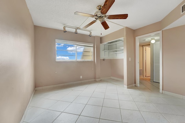 unfurnished bedroom featuring a textured ceiling, a closet, ceiling fan, and light tile patterned flooring