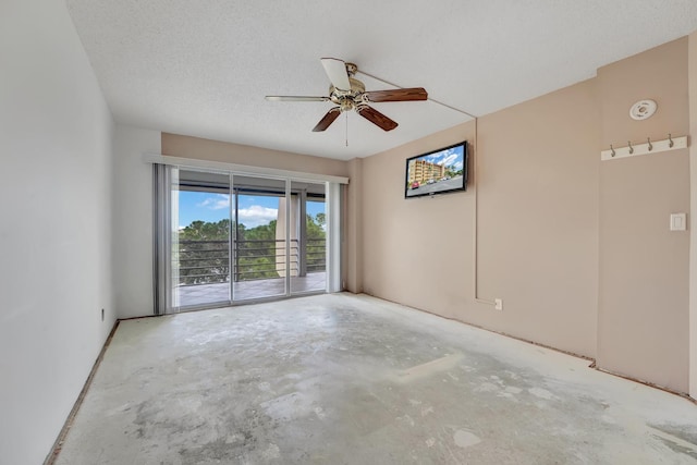 unfurnished room with ceiling fan, a textured ceiling, and concrete floors