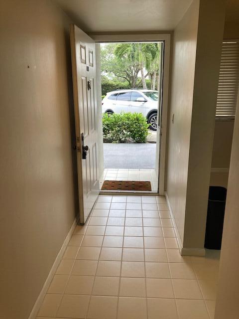 doorway with light tile patterned floors