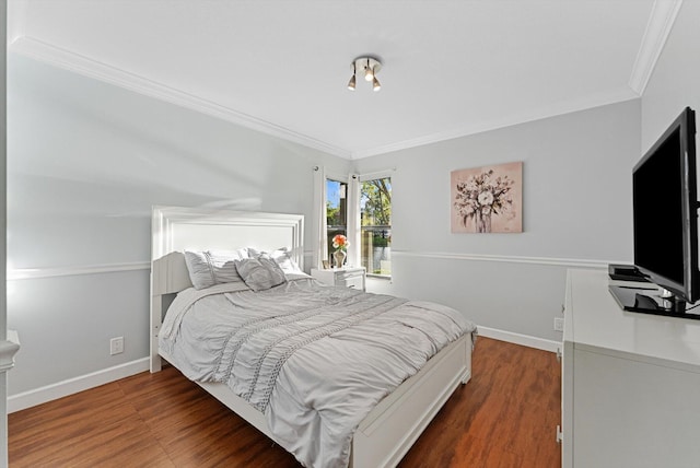 bedroom with dark hardwood / wood-style floors and crown molding