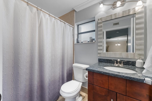 bathroom featuring vanity, toilet, and crown molding