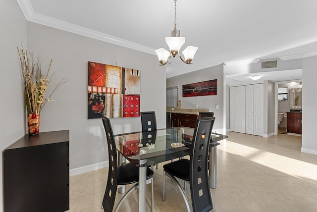 dining space with ornamental molding and a chandelier