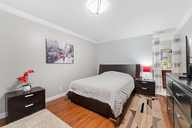 bedroom with ornamental molding and light hardwood / wood-style flooring