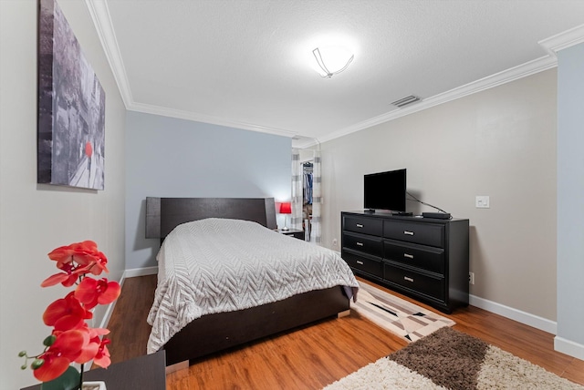 bedroom featuring hardwood / wood-style flooring and ornamental molding