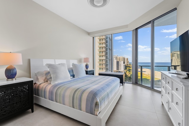 bedroom with multiple windows, floor to ceiling windows, and access to outside