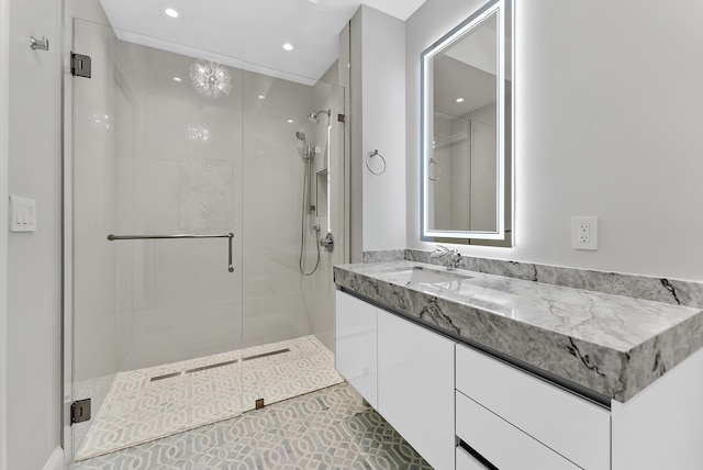 bathroom featuring a shower with door, tile patterned floors, and vanity