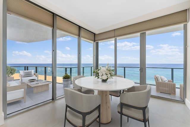 sunroom / solarium with a healthy amount of sunlight and a water view