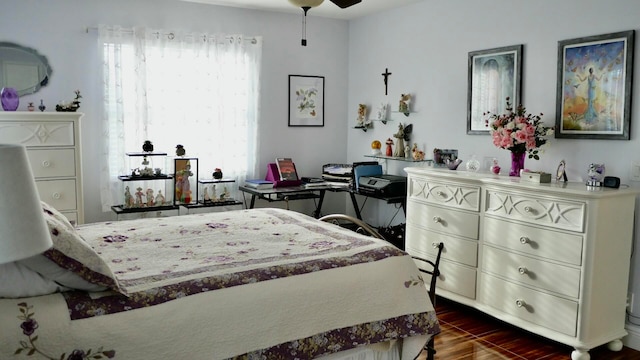 bedroom featuring ceiling fan and dark wood-type flooring