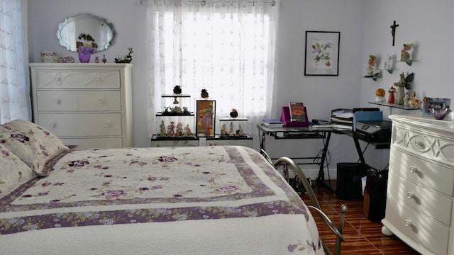 bedroom with dark hardwood / wood-style flooring