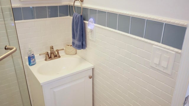 bathroom with vanity and tile walls