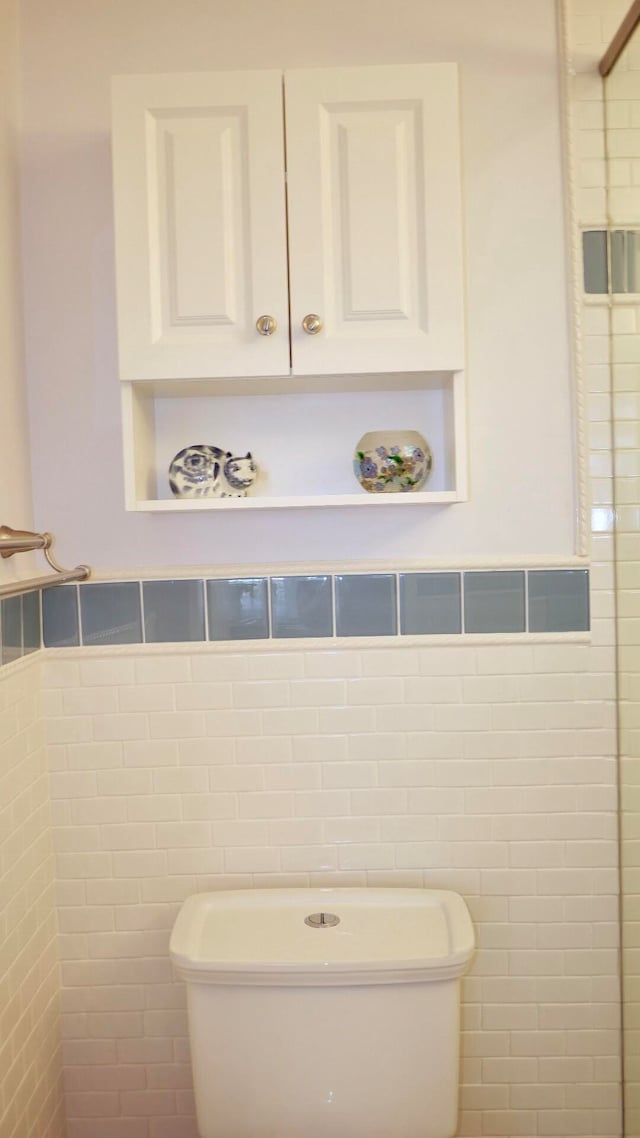 bathroom with tile walls