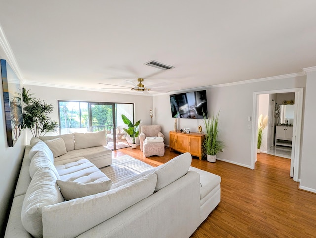 living room with ceiling fan, crown molding, and hardwood / wood-style flooring