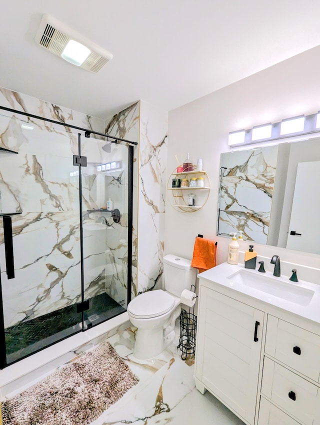 bathroom featuring a shower with door, vanity, and toilet