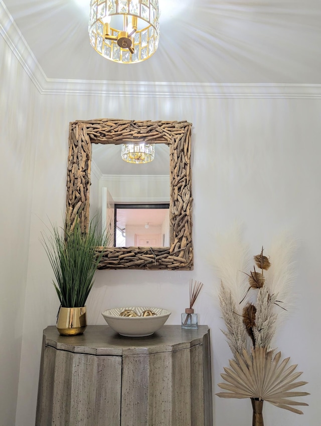 interior details with ornamental molding and an inviting chandelier