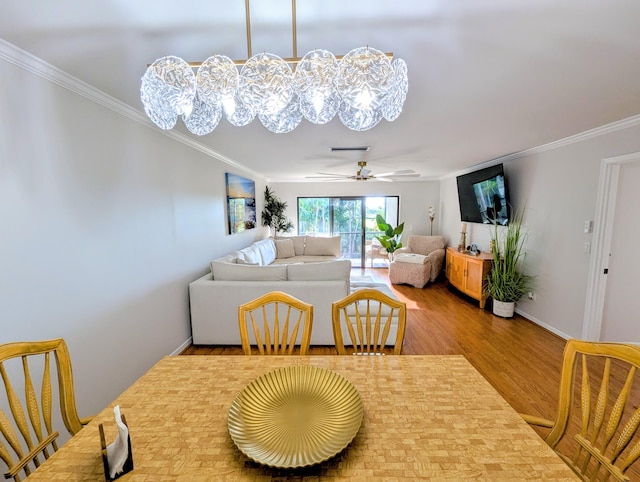 dining area featuring crown molding, hardwood / wood-style floors, and ceiling fan